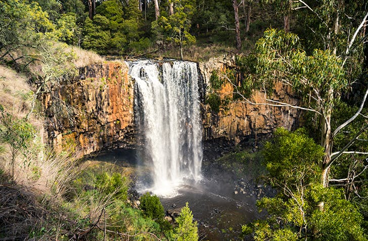 Trentham Falls gushing down a large rock wall.