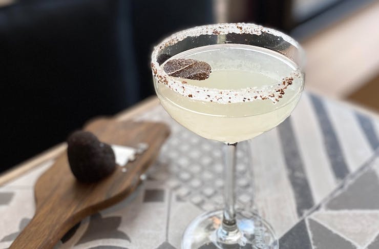 a margarita with a truffle shaving on top