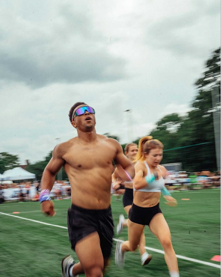 Turf Games athletes in activewear sprint across astroturf.