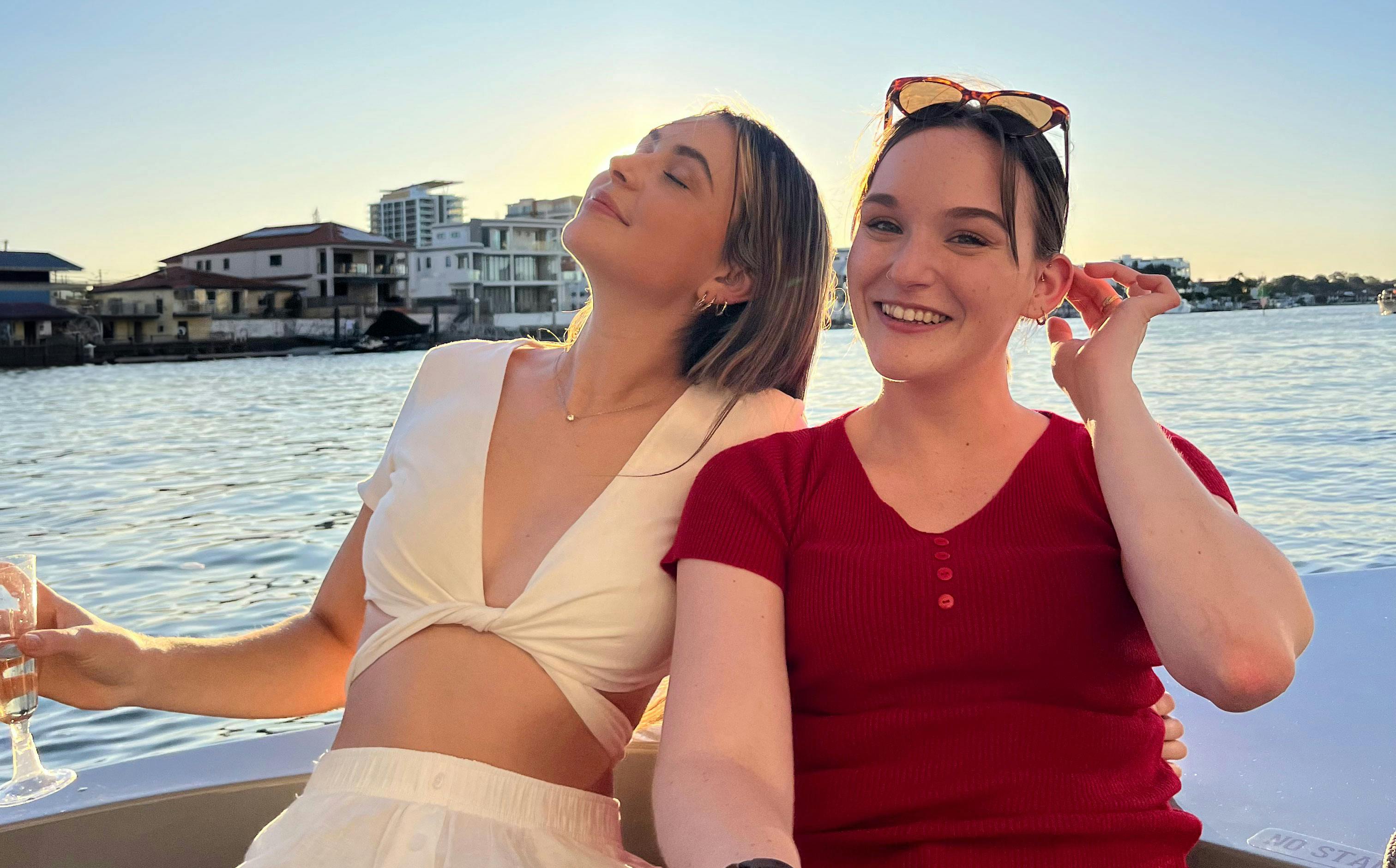 Two girls on a boat enjoying the summer sun