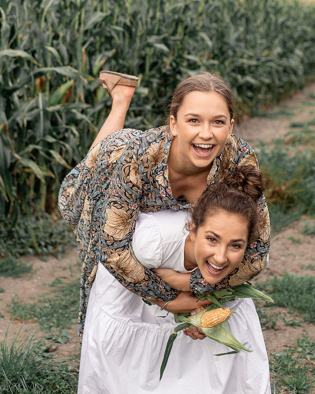 Margo and Rosa play around in a field.