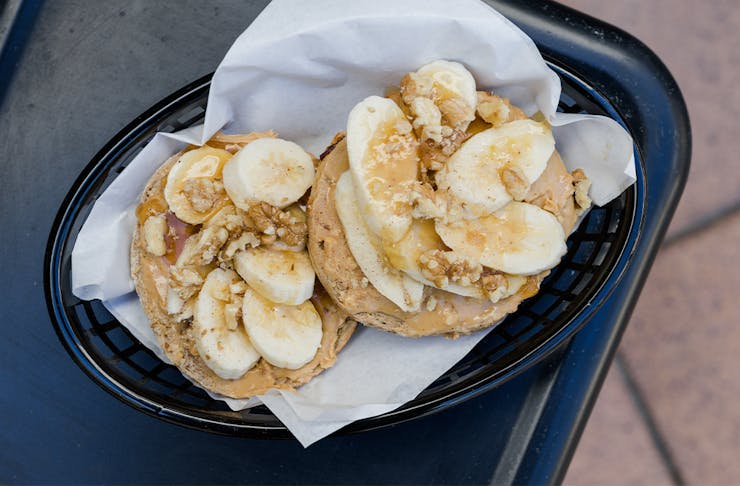 a banana and peanut butter topped bagel
