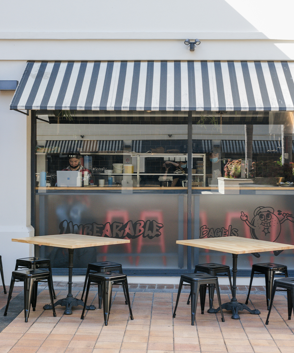 exterior of unbearable bagels, with tables outside