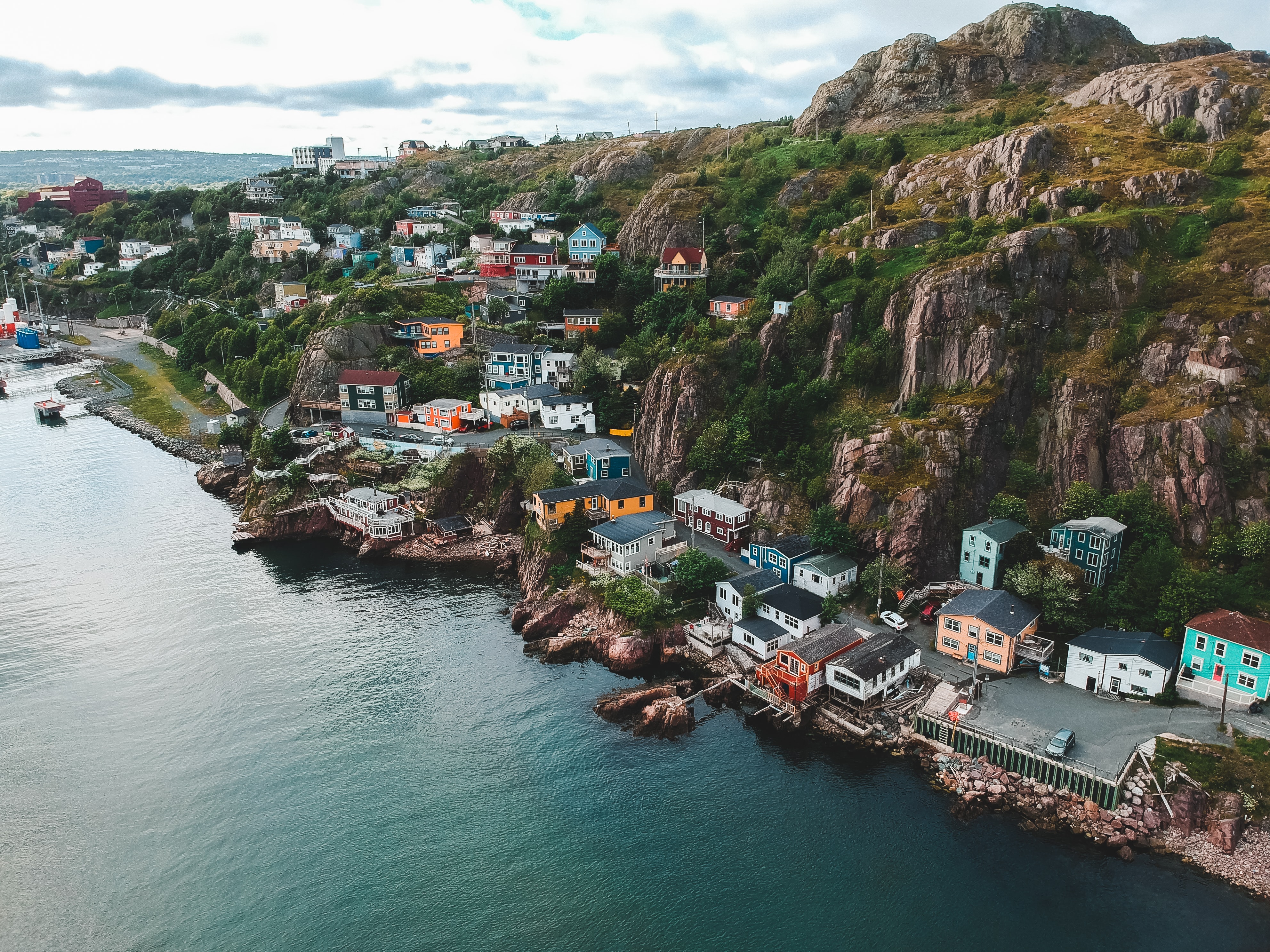a cliffslide in newfoundland dotted with colourful houses