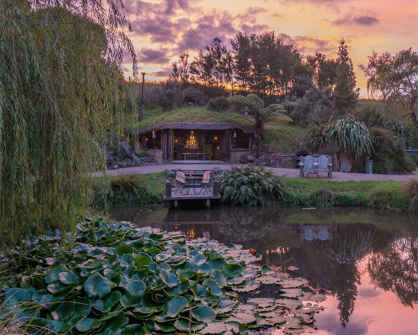 Underhill Valley is seen in front of a beautiful pond at sunset.