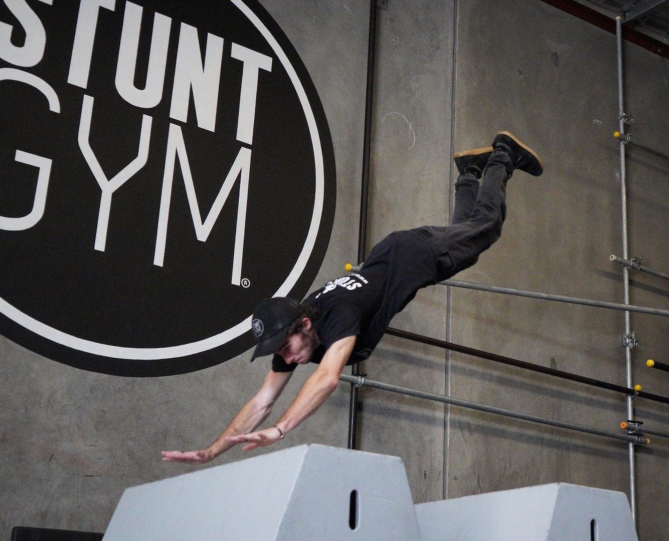 A man leaps from a platform in a parkour stunt