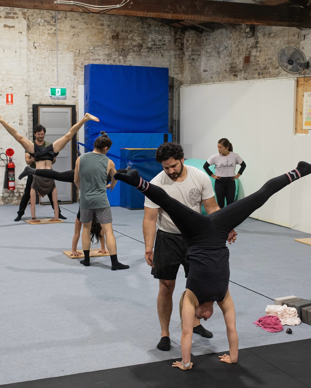 people dong acrobatic stretches and handstands in a sydney gym