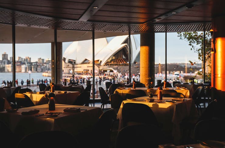Aria restaurant dining room at sunset, with the Sydney Opera House in the background