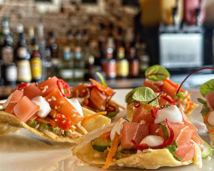 A close up of Vandal's plant-based soft tacos, open to reveal the inside filling.