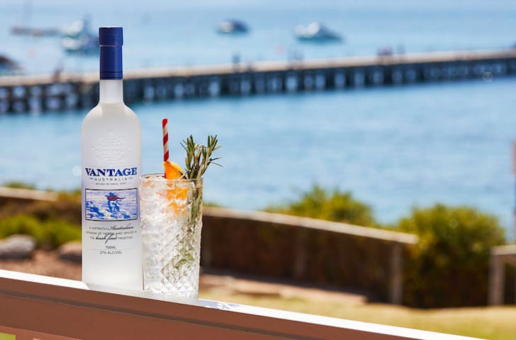 A bottle of Vantage beside a coktail