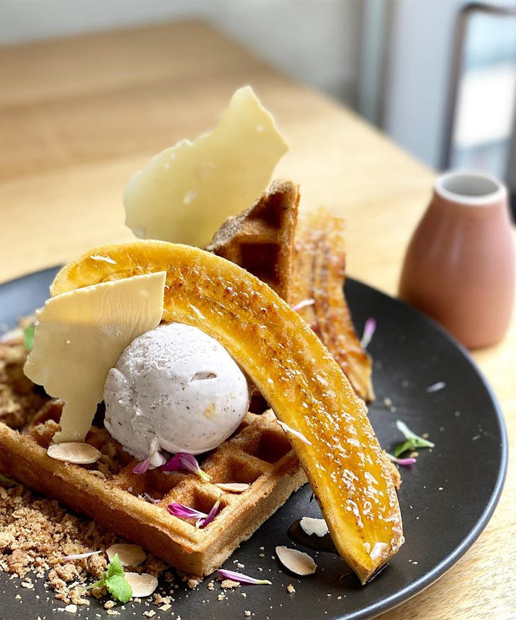 a plate of waffles with banana