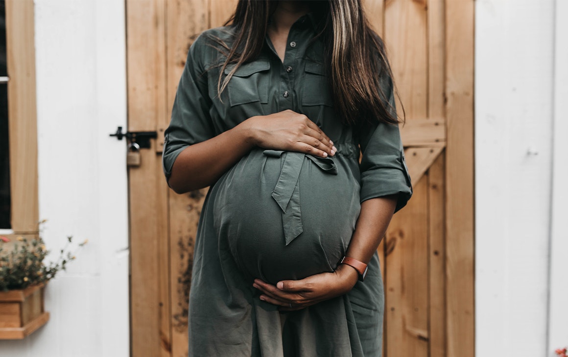 a pregnant woman holding her stomach