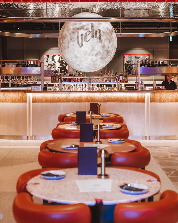 vela, a brisbane thai restaurant with a large moon over the bar