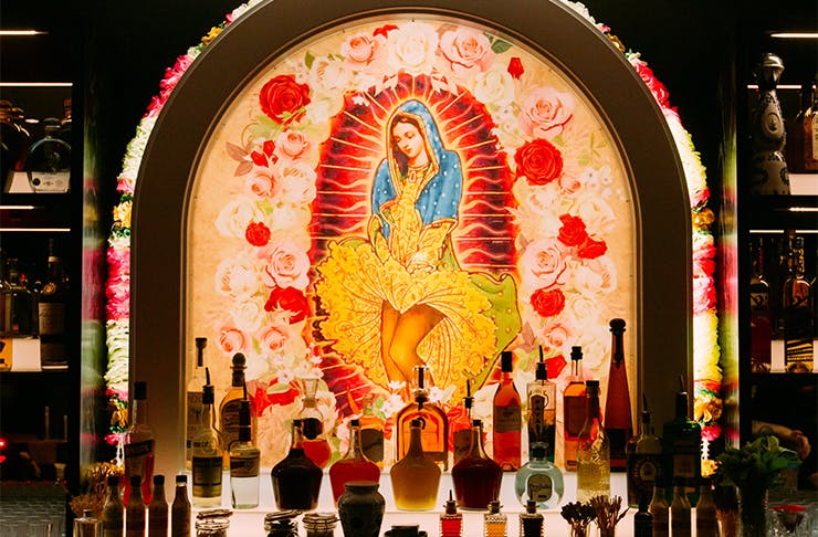 A neon-lit icon of the Virgin Mary behind the bar at Gold Coast's new hidden speakeasy.