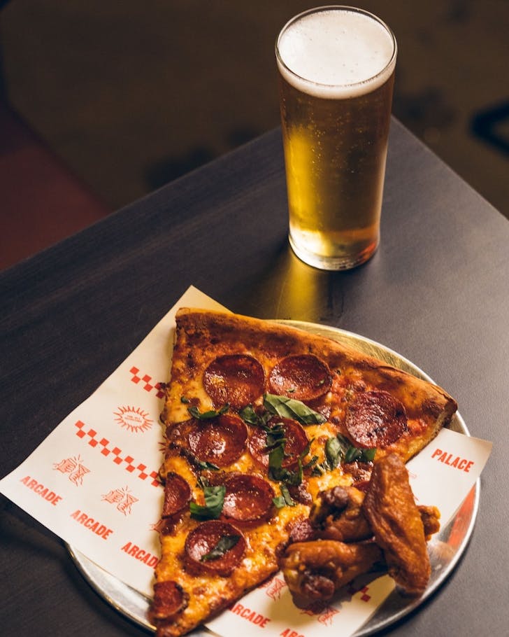 A slice of pizza and wings at Palace Arcade in Victoria Park