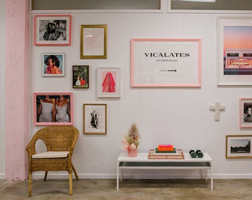 A white wall covered in framed pictures