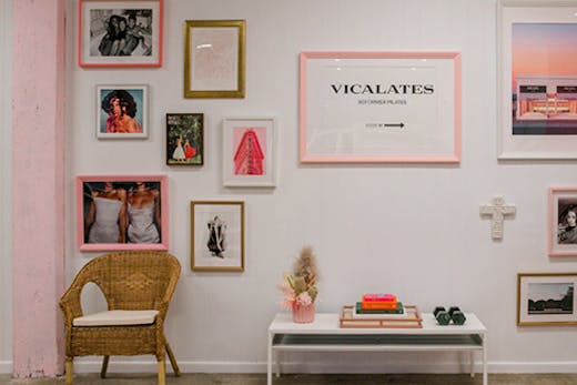 A white wall covered in framed pictures