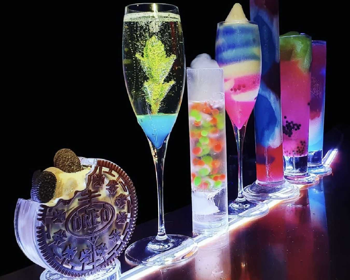 a row of glow in the dark cocktails at brisbane cocktail bar Viscosity