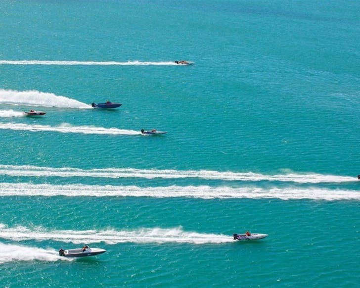 Speed boats race across the blue waters of Lake Macquarie
