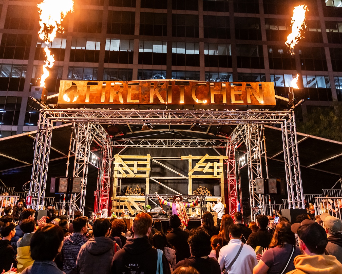 the main stage with flames surrounding a performer at vivid fire kitchen, returning in 2025