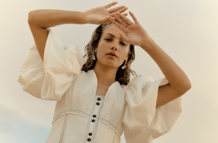 A model wearing a white Aje dress