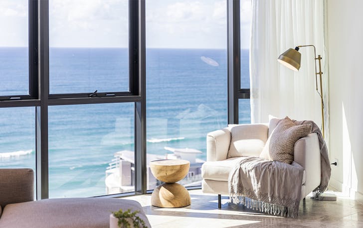 a chair sitting in front of a window with a view 