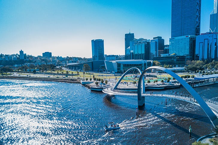 A bridge passing over a waterway in Perth CBD on a sunny day.