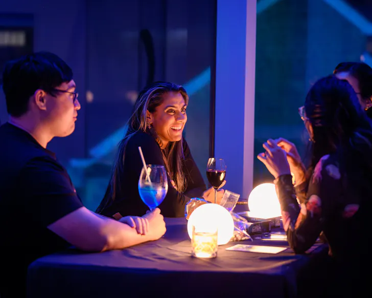 Three people sitting at high table