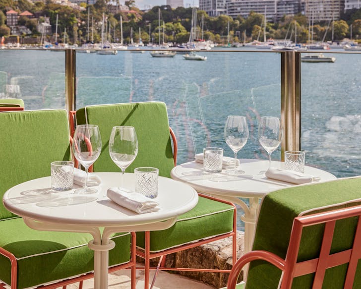 Green lounge chairs at sails on lavender bay, one of the best waterfront restaurants in Sydney