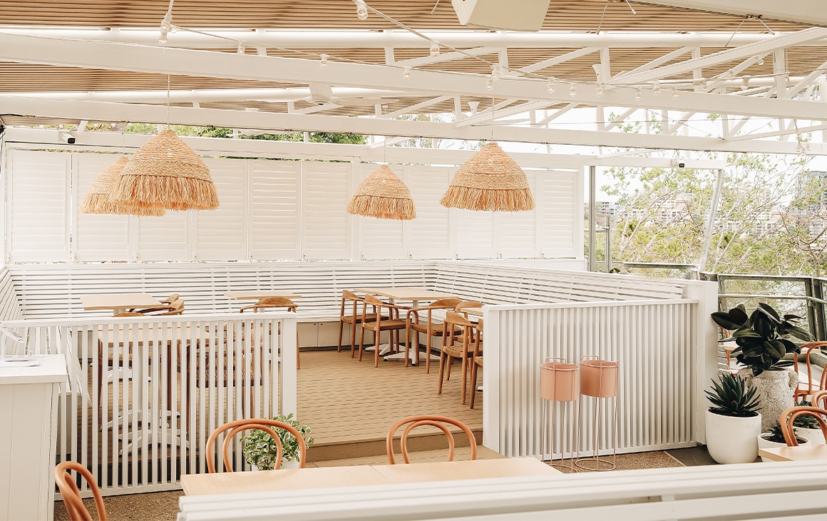 a white dining area overlooking the brisbane river at joeys