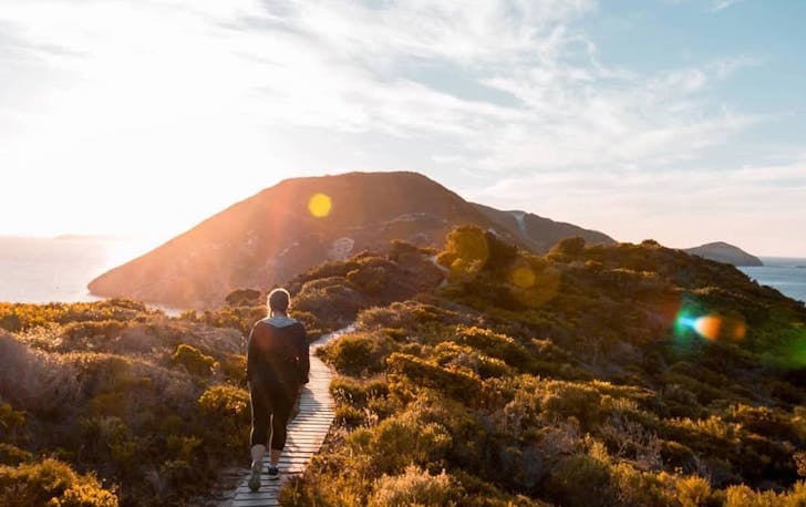 A person hikes Bald Head in Albany