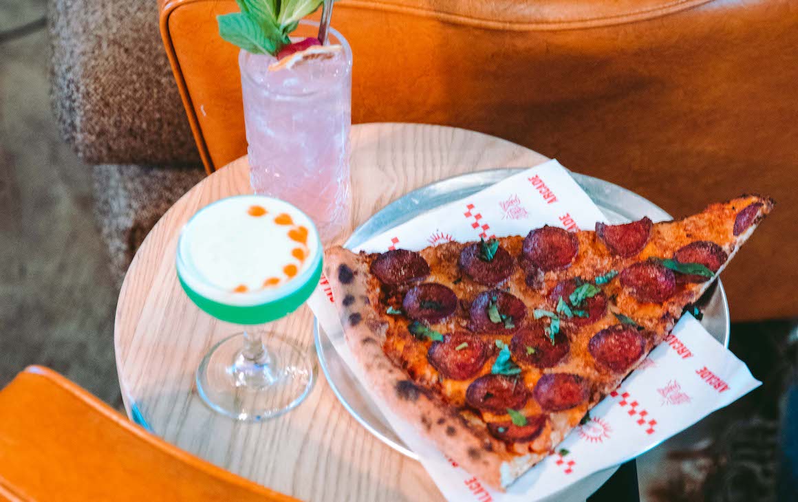 A slice of pizza and cocktails