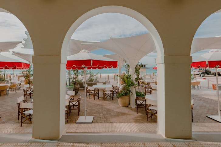 The white arches at red umbrellas on the terrace at Promenade restaurant, which is open on the Easter Long Weekend