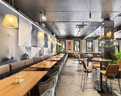 a dining space with an artistic wall