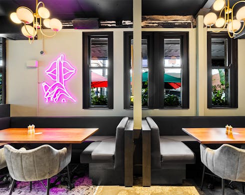 dark booths below neon lights