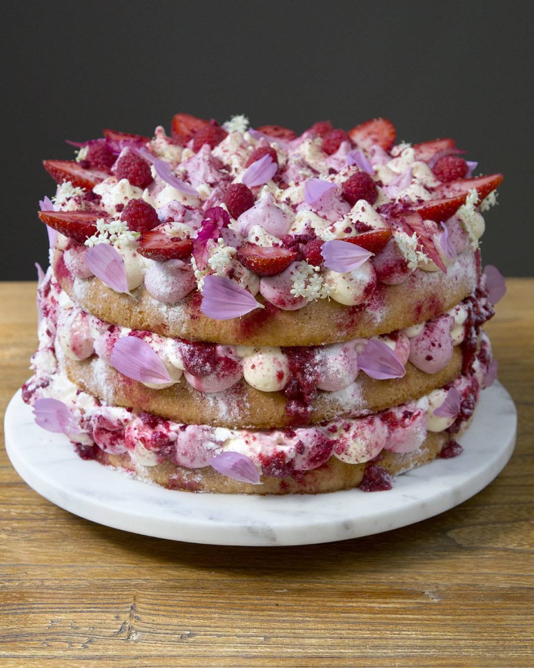 sponge cake covered in pink flowers