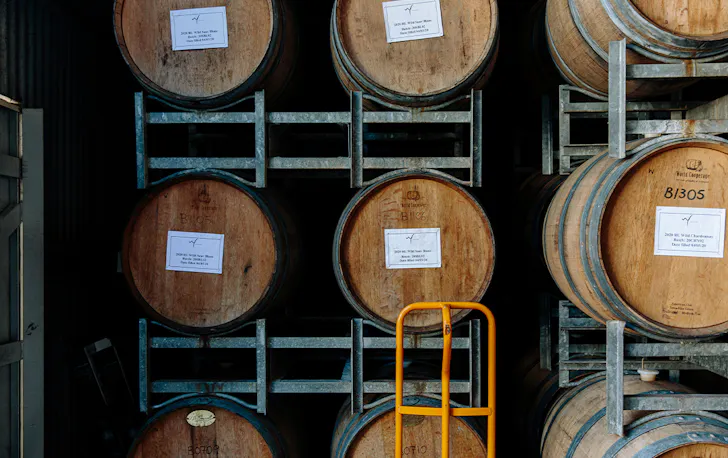 wine barrels stacked in a framework