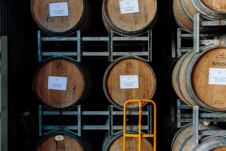 wine barrels stacked in a framework