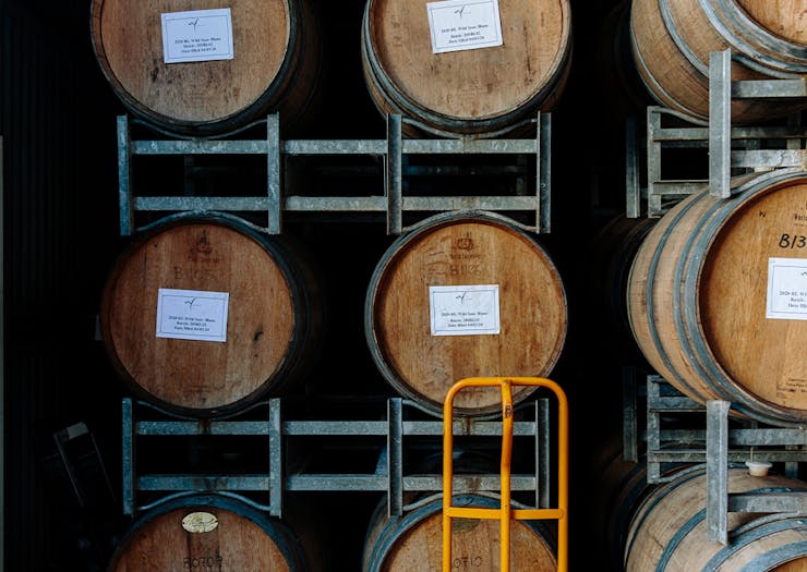 wine barrels stacked in a framework