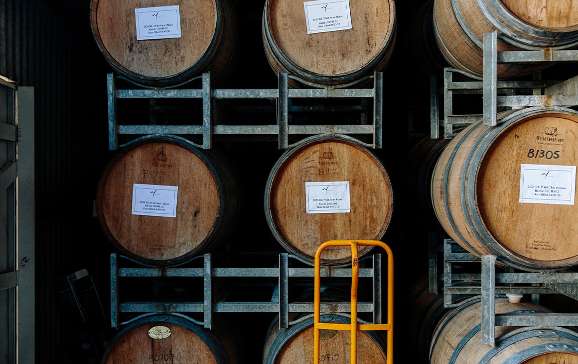 wine barrels stacked in a framework