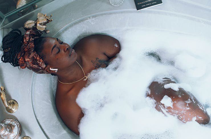 A woman relaxes in a lovely bubble bath.