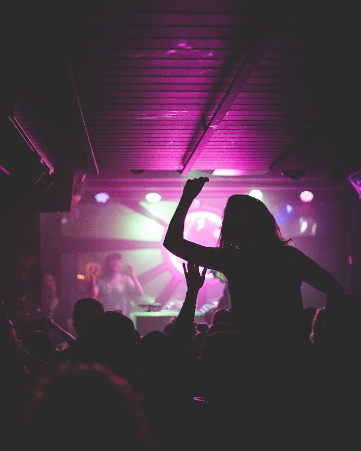 Yonder guests dance on a neon-lit dancefloor
