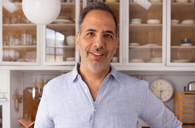 A portrait of chef Yotam Ottolenghi in a kitchen.