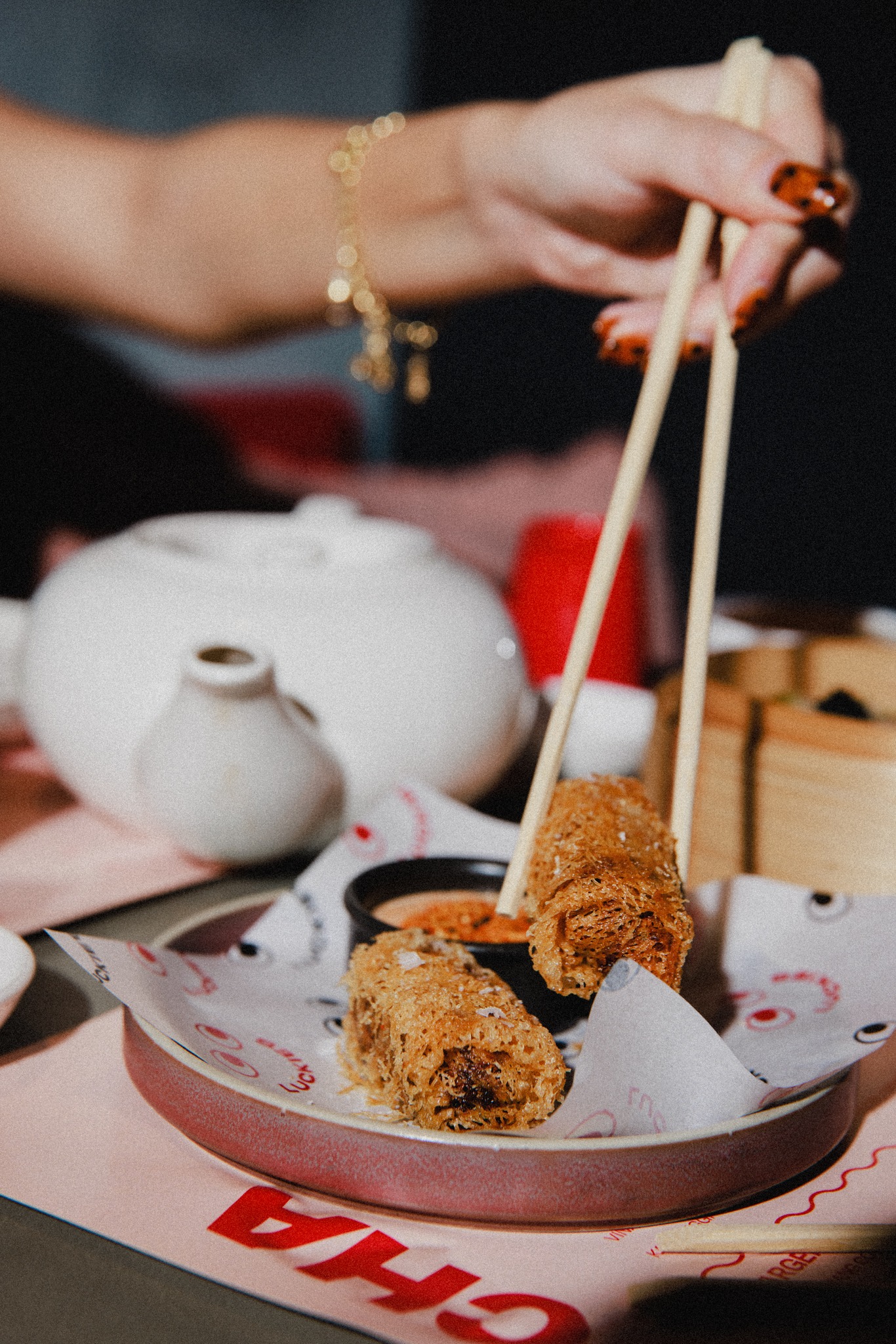 chopsticks being used to pick up egg rolls at yum cha at Brisbane's Luckies 