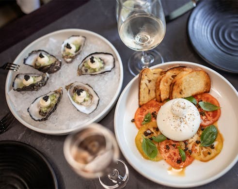 plates of oysters and burrata