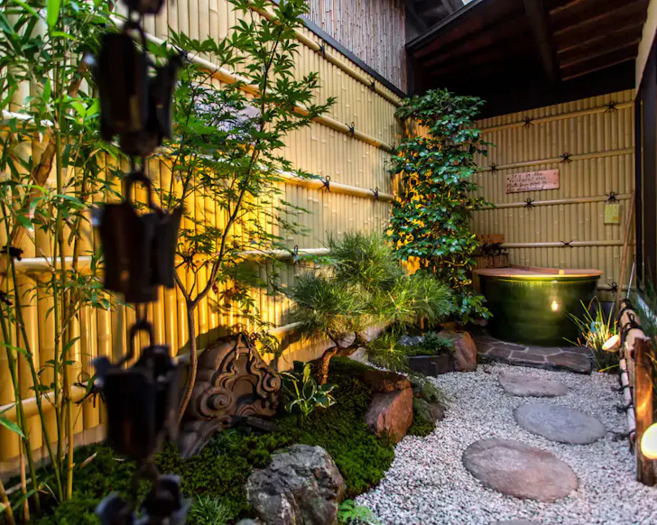The outdoor zen garden at Shukuhonjin Gamo Bungalow Airbnb in Osaka.
