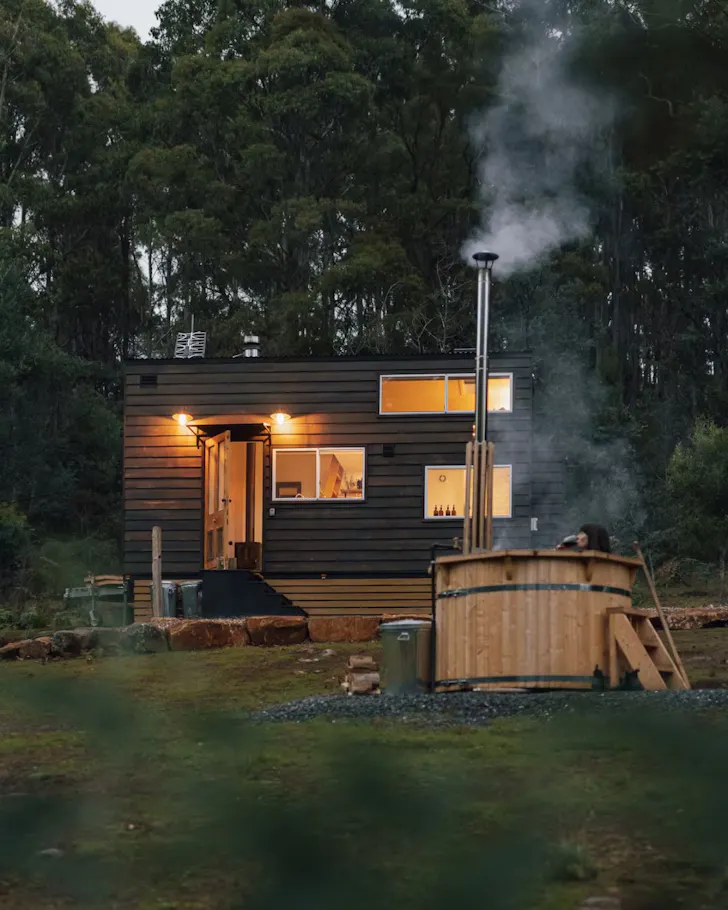 A view of ​Naivasha Tiny House and its hot tub in Tasmania