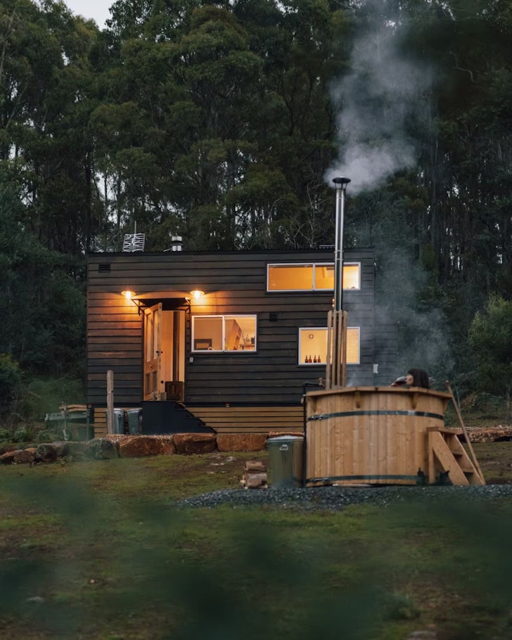 A view of ​Naivasha Tiny House and its hot tub in Tasmania