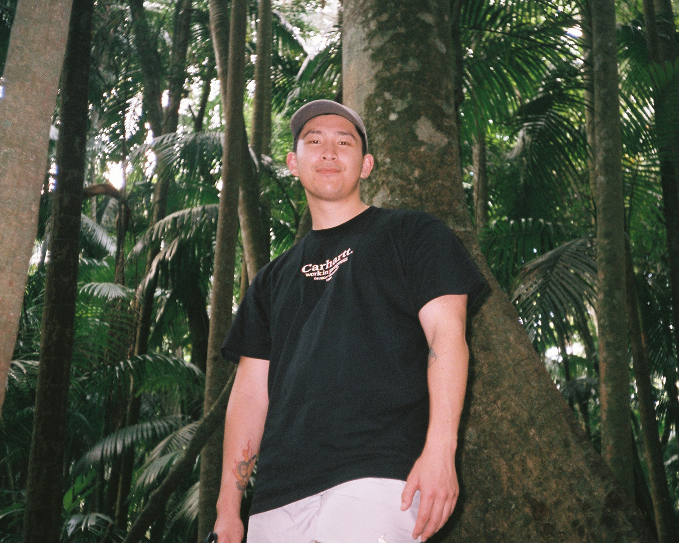 Tai Pham standing in front of a lush forest 