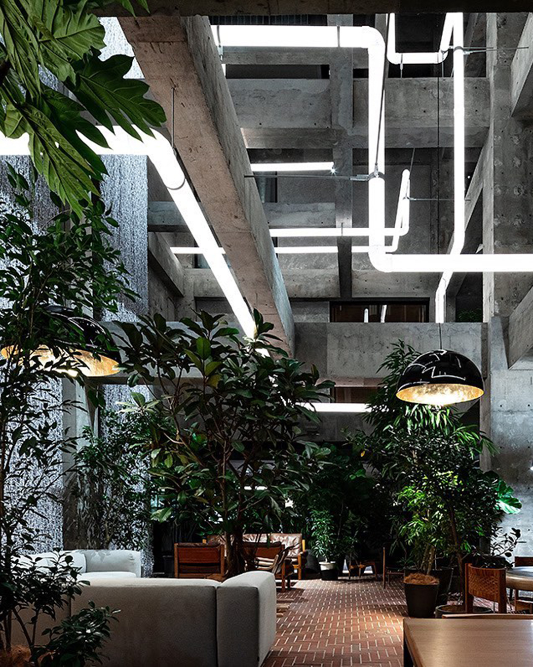 The lush green, and industrial grey contrast in the Shiroiya Ryokan lobby